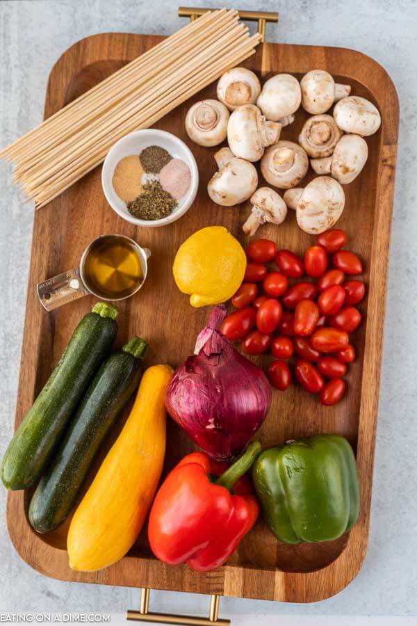 ingredients needed for vegetable kabobs: mushrooms, cherry tomatoes, zucchini, yellow squash, peppers, seasoning