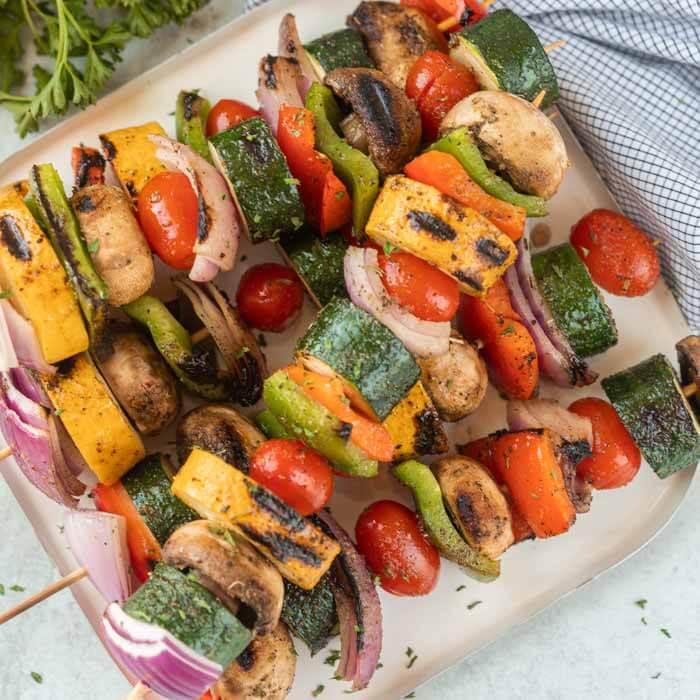 grilled vegetable skewers on a white plate