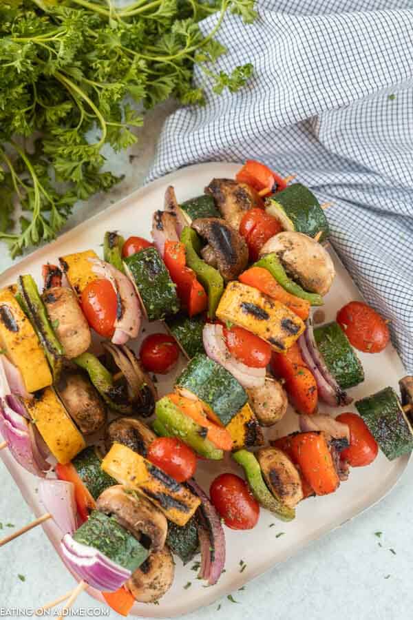 grilled veggie skewers on a white plate