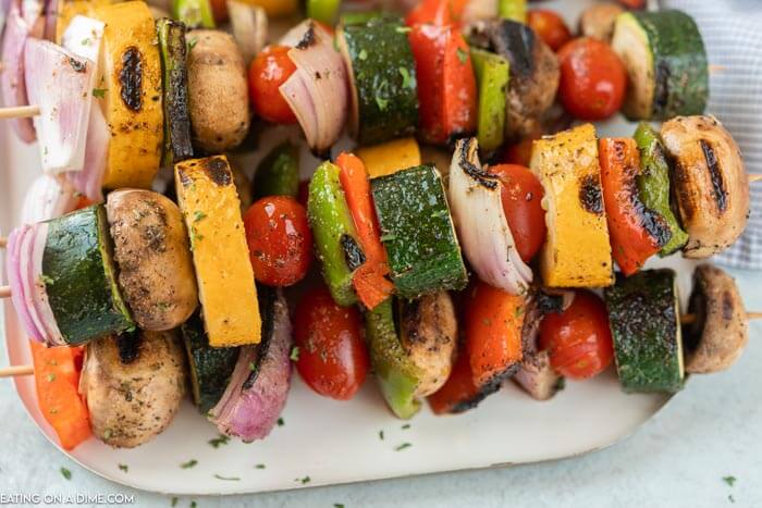 grilled veggie kabobs on a white plate