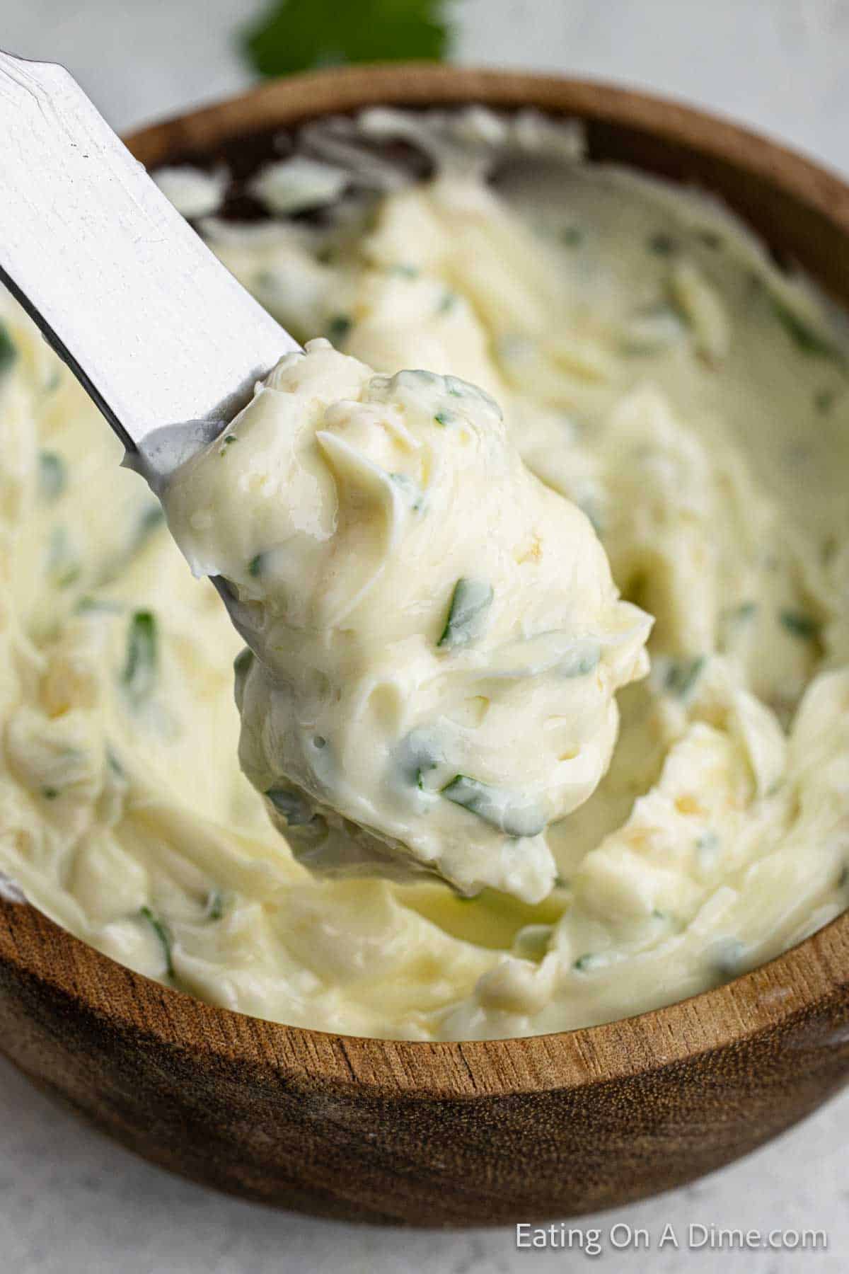 Close up image of garlic butter on a knife