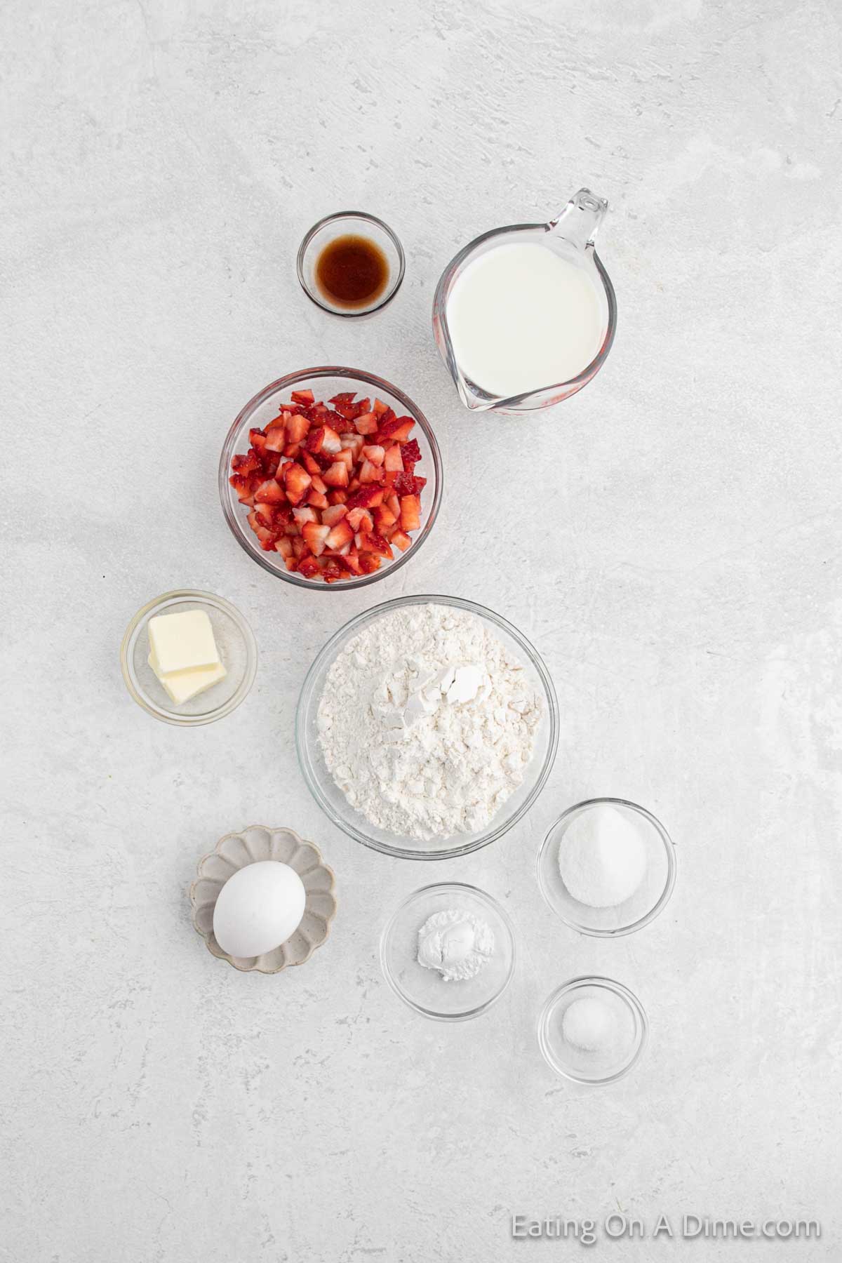 Strawberry Pancakes ingredients - sugar, baking powder, salt, milk, egg, butter, vanilla extract, strawberries, maple syrup