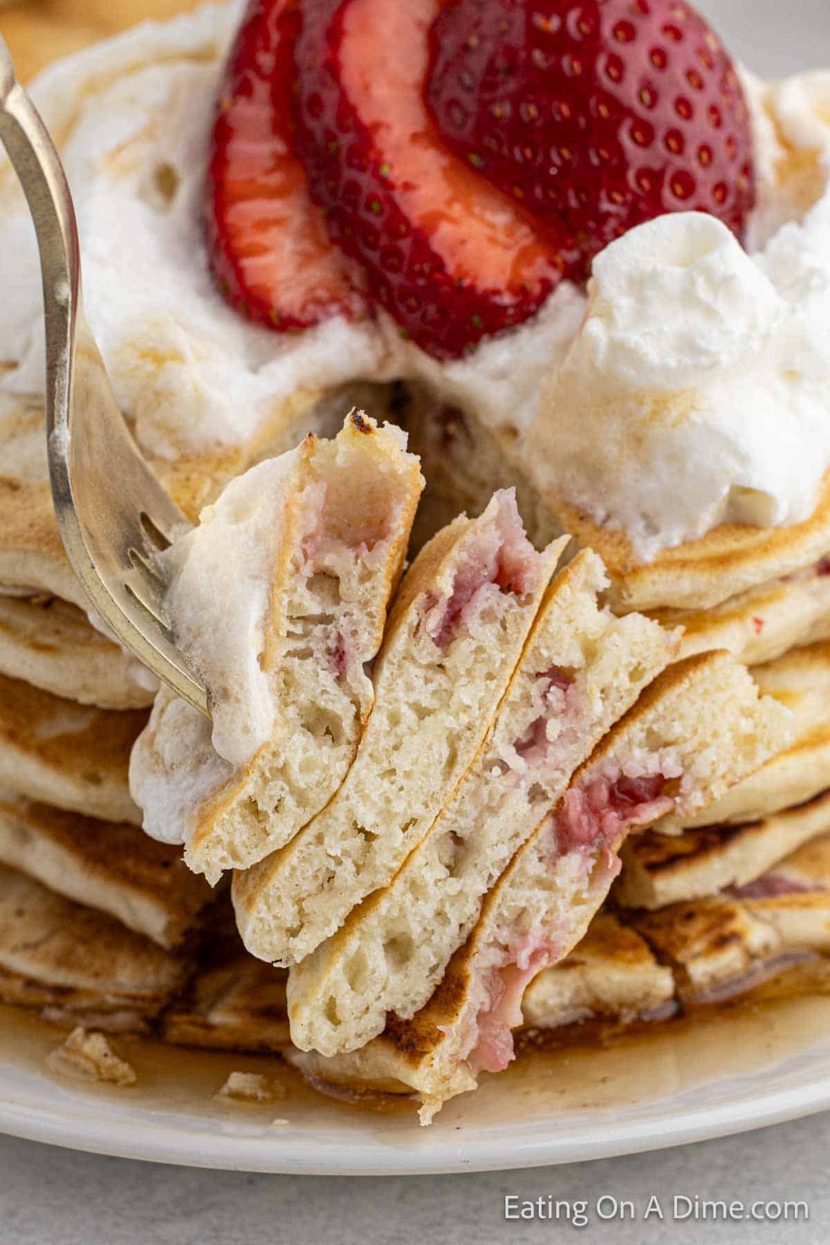 Close up image of stacked pancakes on a fork