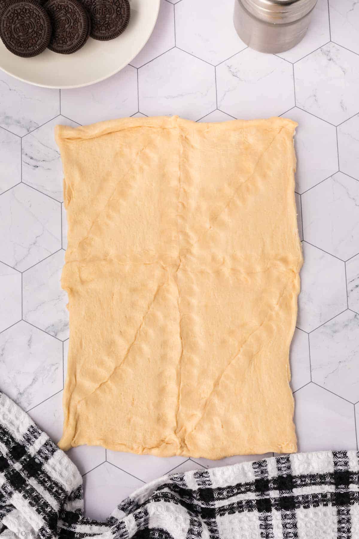 Crescent Roll dough with a plate of Oreos on the side
