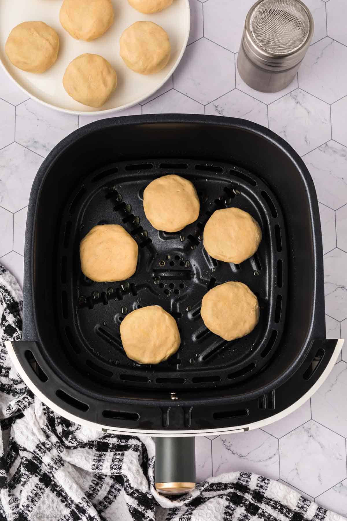 Oreos covered with Crescent Roll Dough in an air fryer basket 