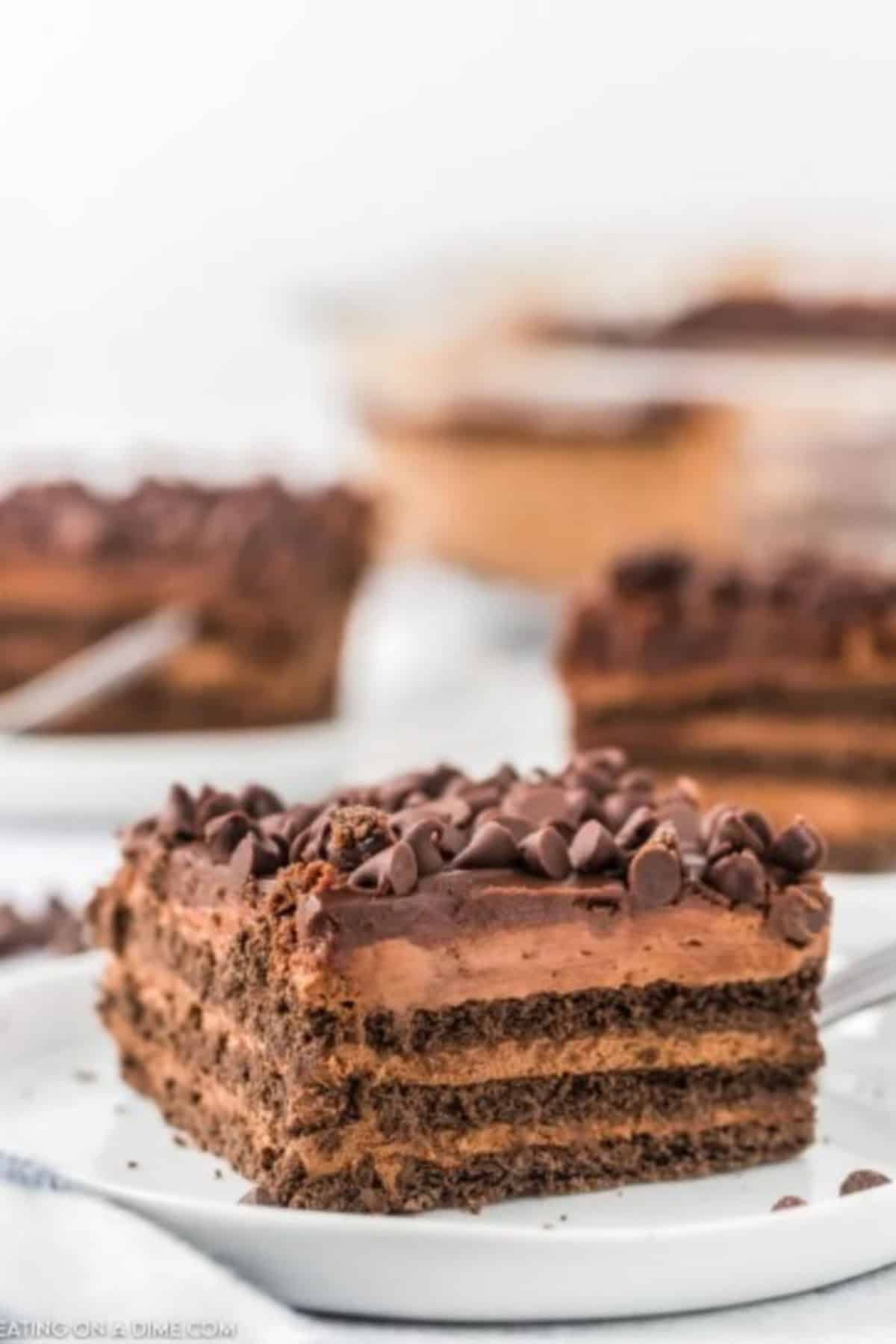 piece of chocolate icebox cake on a white plate.
