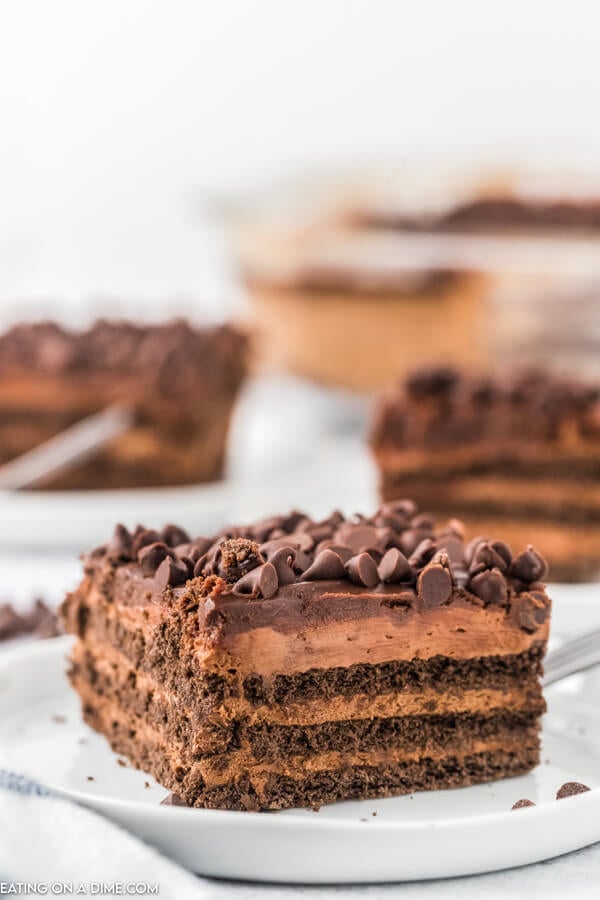 Close up image of a piece of chocolate icebox cake on a white plate. 