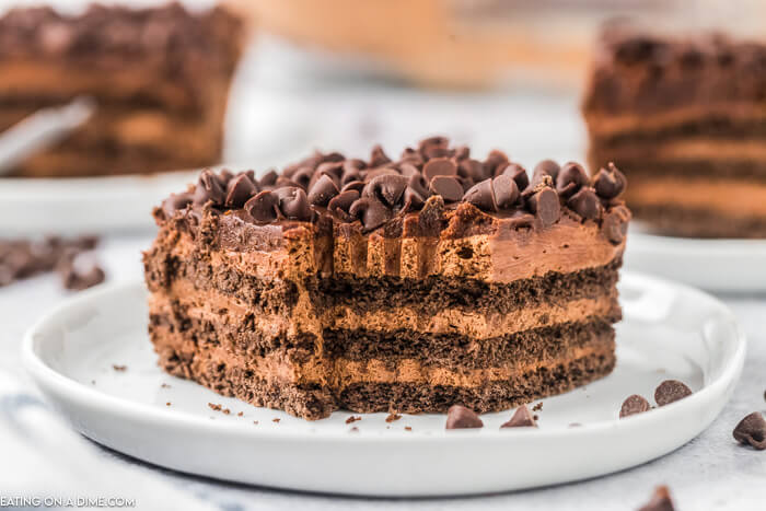 Close up image of a piece of chocolate icebox cake on a white plate. 