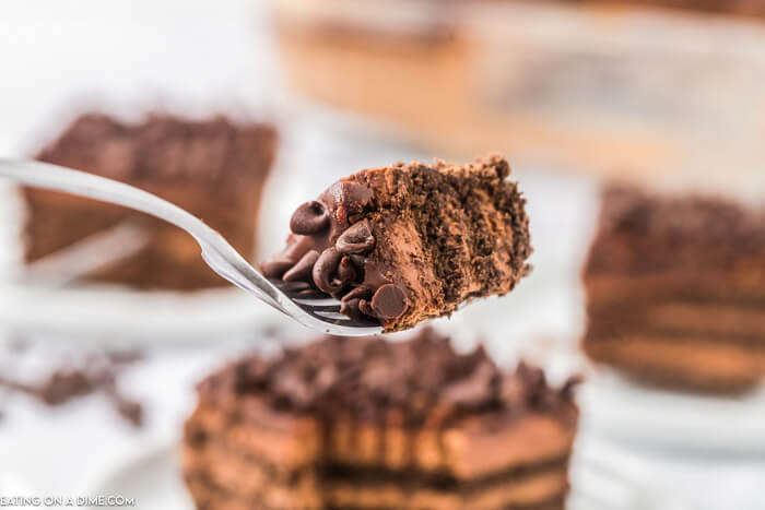 Close up image of a serving of chocolate icebox cake on a fork. 