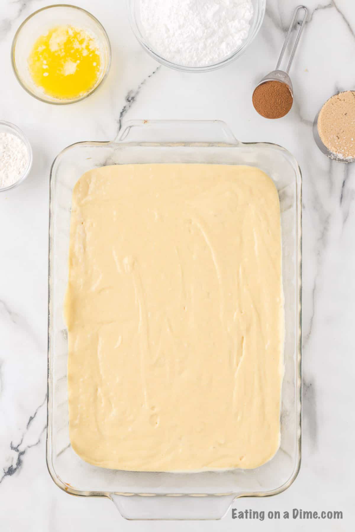 The cake batter poured into a baking pan.