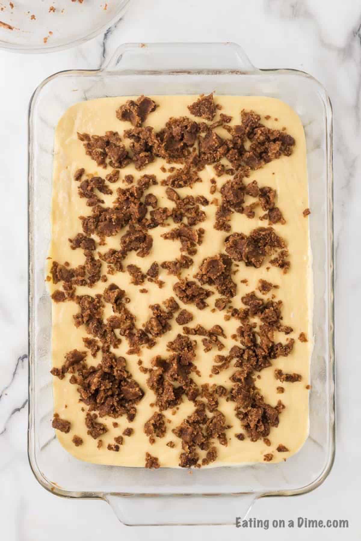 The streusel topping dropped into the batter in the baking dish.