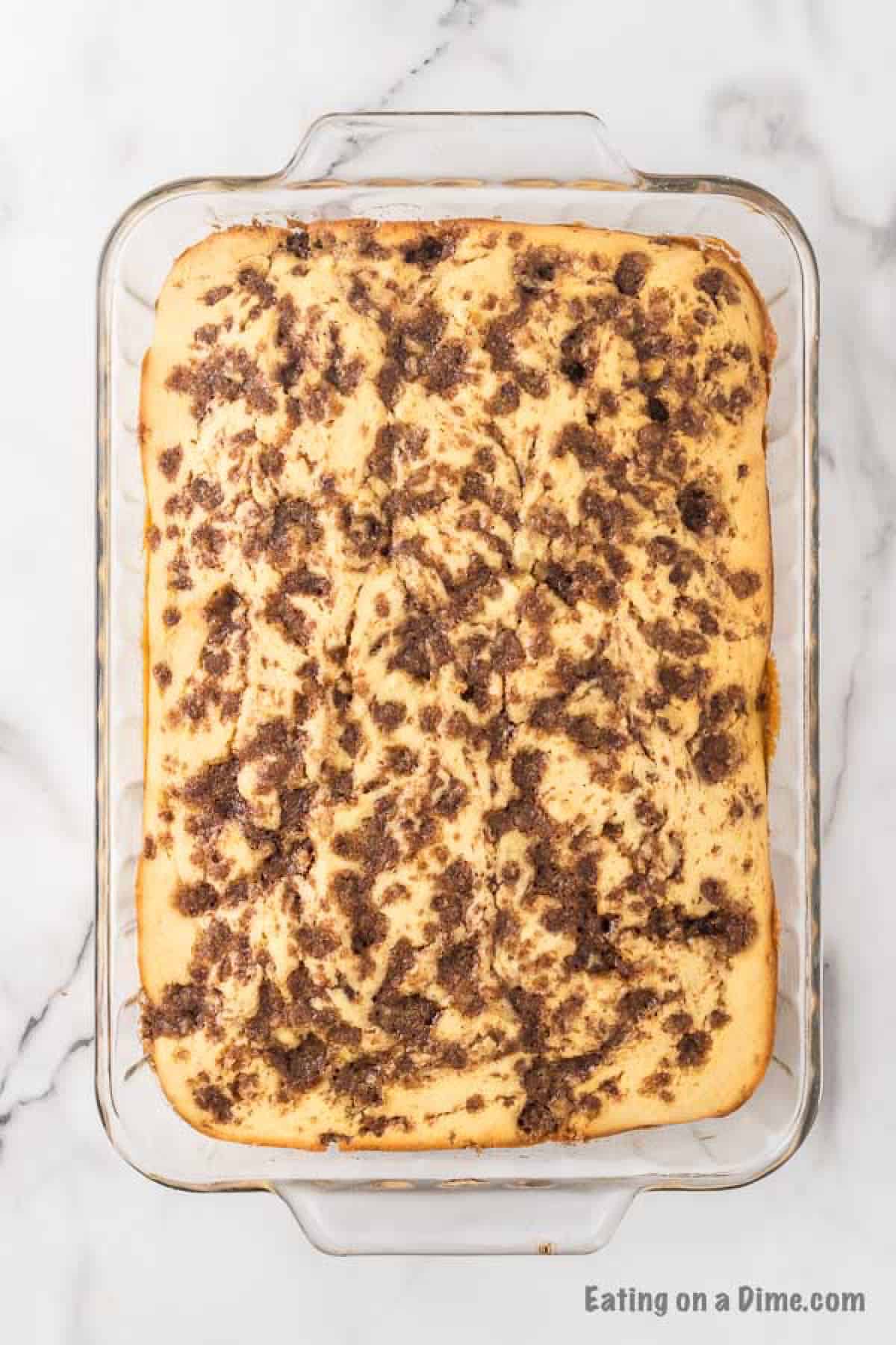The cake baked and cooling in a pan.
