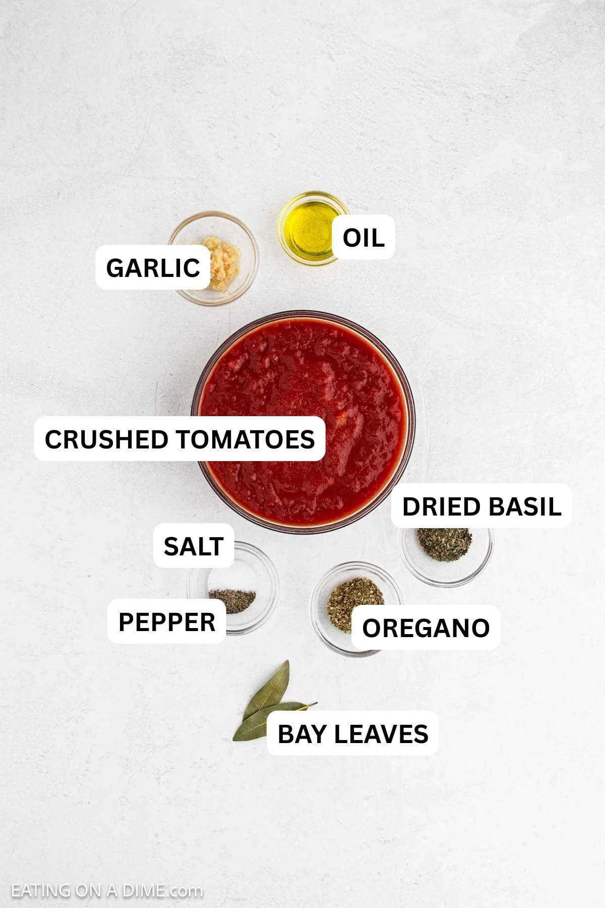 Ingredients needed for this recipe includes crushed tomatoes, basil, oregano, bay leaves, garlic, pepper, salt, and oil.