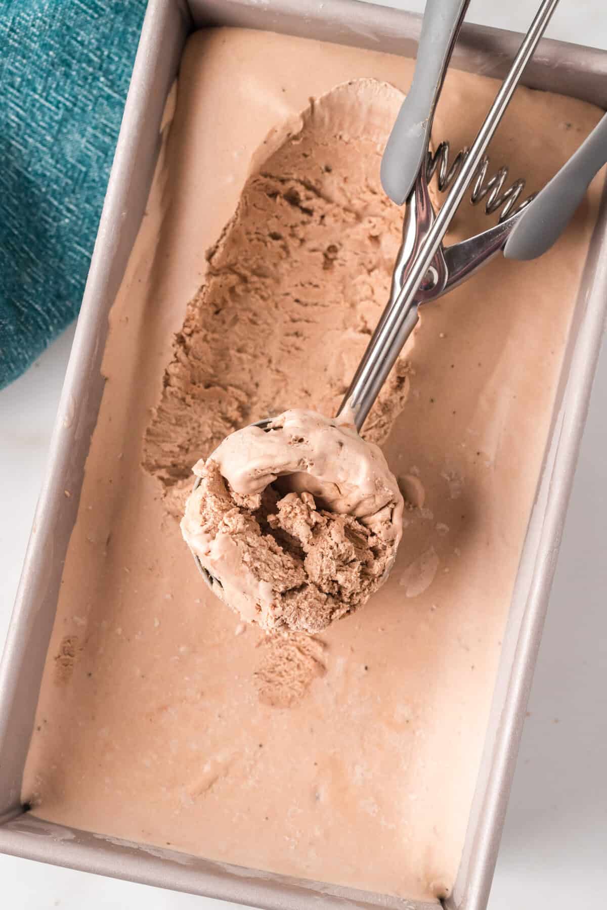 Ice cream scoop serving ice cream from the loaf pan.