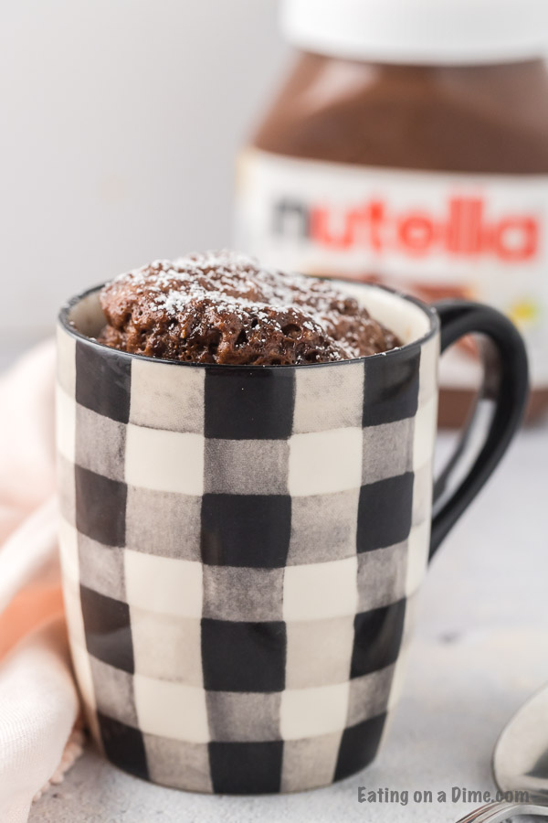 Black and white mug with nutella mug cake inside. 