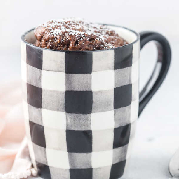 Black and white mug with nutella mug cake inside. 