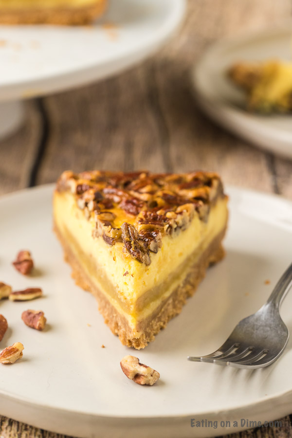 slice of pecan pie cheesecake on a plate