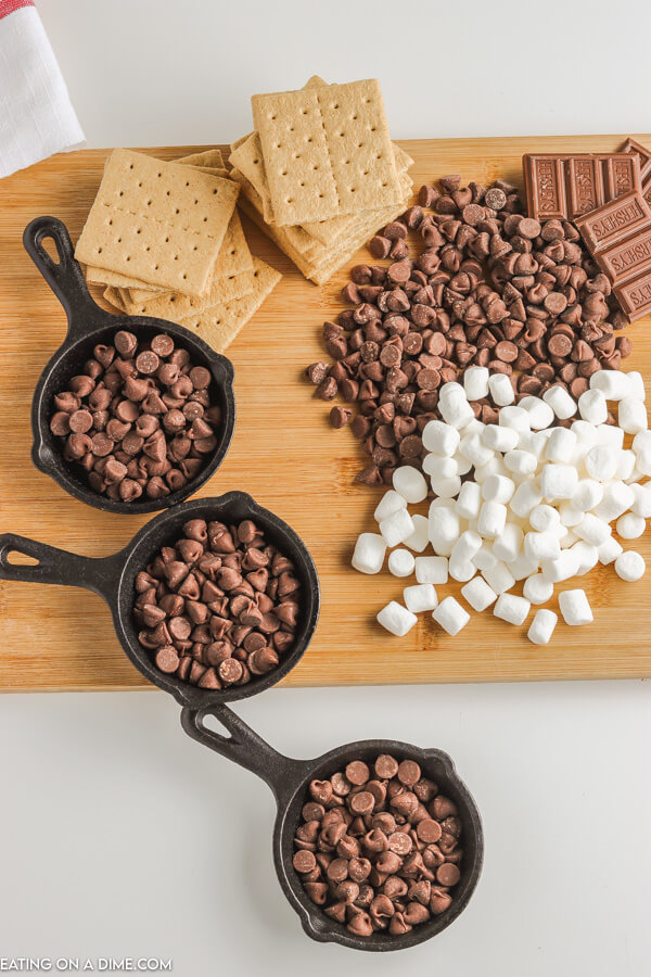 skillets with milk chocolate morsels and other ingredients surrounding it
