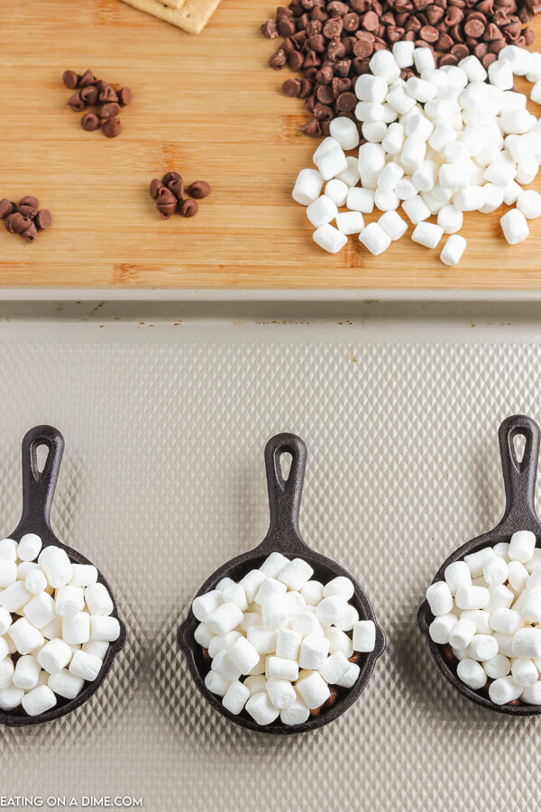 skillets topped with marshmallows ready to be baked