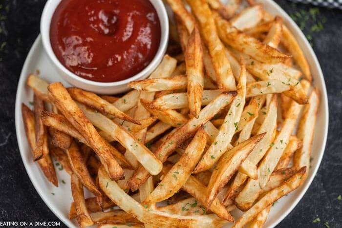 Plate of French fries with ketchup.