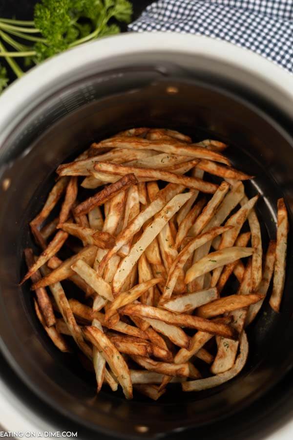 French fries in air fryer basket. 