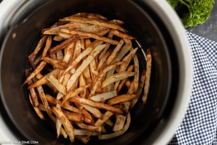French fries in air fryer basket. 