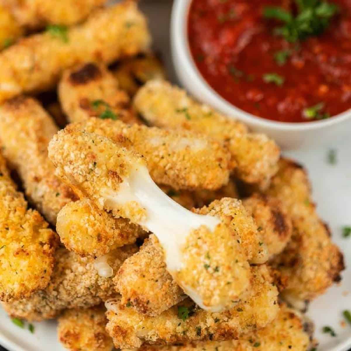 picture of mozzarella sticks with marinara sauce.
