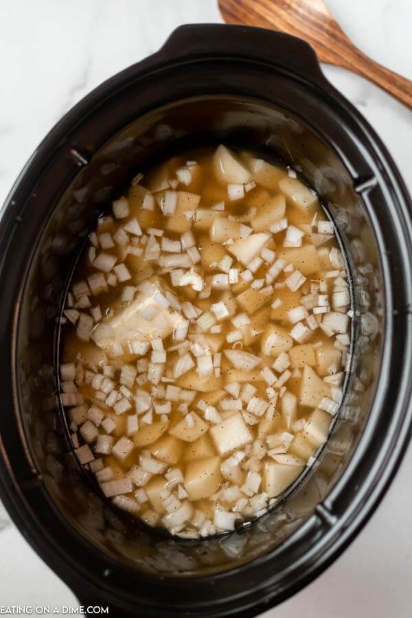 diced potatoes and broth in crock pot ready to cook