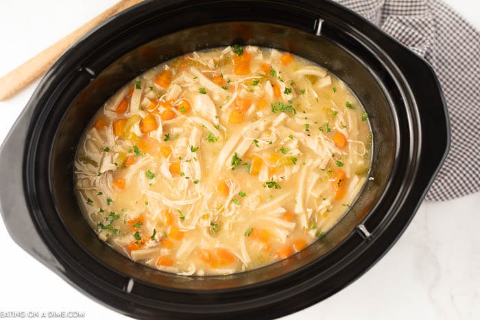Close up image of chicken noodle soup in the crockpot. 
