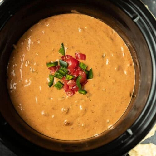 Close up of chili cheese dip in a small crock pot.