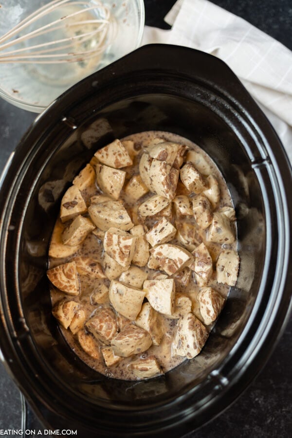 Close up image of crock pot cinnamon roll casserole in processing. 