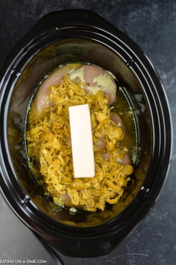 Close up image of the ingredients for Mississippi chicken in a crock pot. 