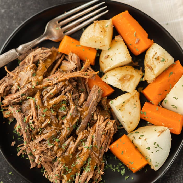 plate of shredded roast, potatoes and carrots