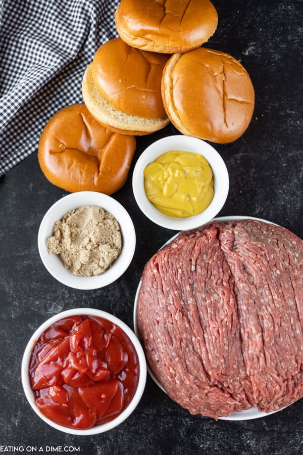 Close up image of ingredients for sloppy joes. It includes hamburger buns, uncooked ground beef, mustard, brown sugar and ketchup. 