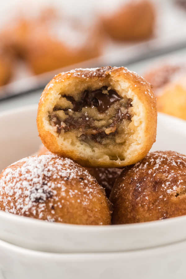 Close up image of deep fried cookie dough in a bowl. 