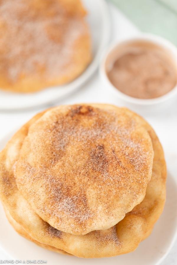 Plate of elephant ears topped with cinnamon sugar. 