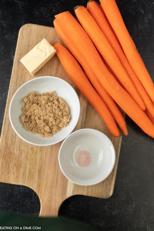Close image of ingredients for brown sugar glazed carrots - carrots, brown sugar, salt and butter. 