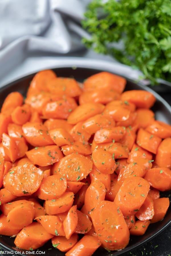 Close up image of brown sugar glazed carrots in a skillet. 