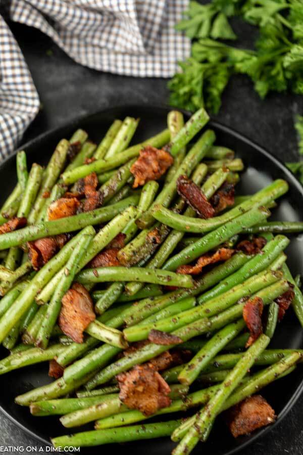 Make green beans with bacon for a savory and delicious side dish. With just a few ingredients, this recipe is simple but loaded with flavor. 