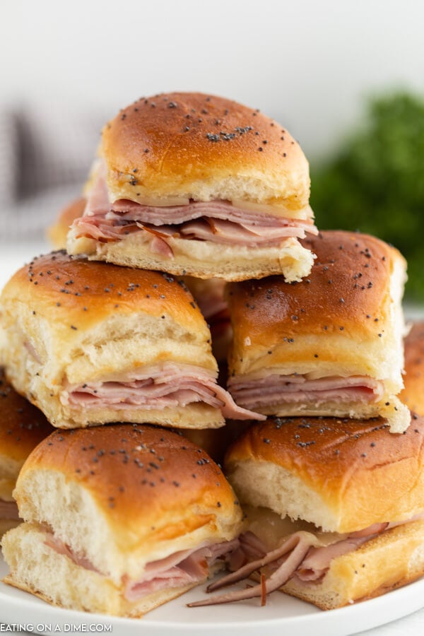 Close up image of ham and cheese sliders stacked. 