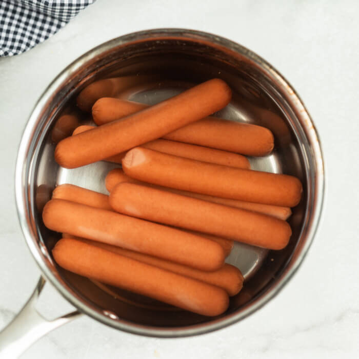 Hot dogs in a pan. 