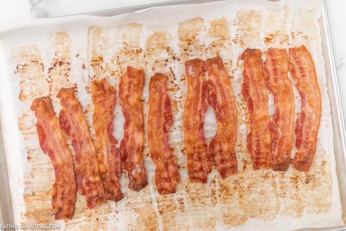 cooked bacon slices on baking sheet