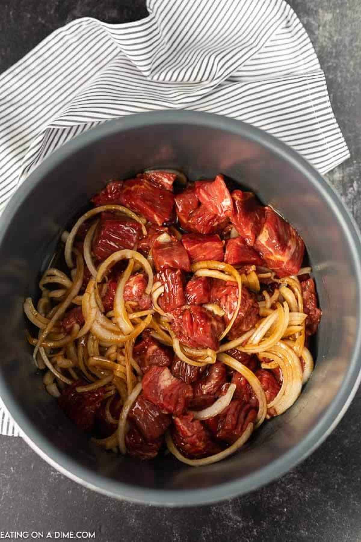 All the raw ingredients in an instant pot insert 