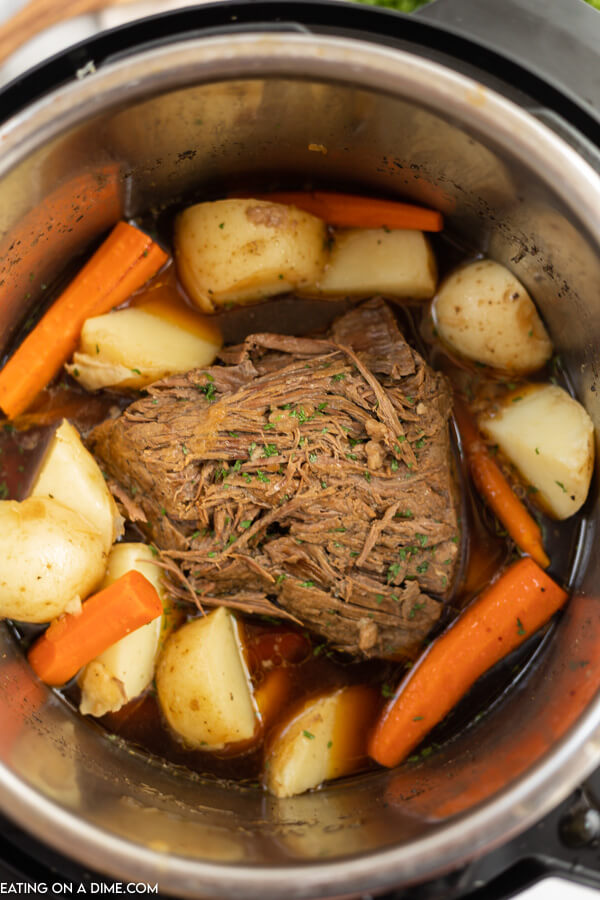 Roast in pressure cooker with gravy, potatoes and carrots. 