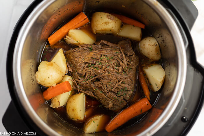 Instant pot with roast and vegetables inside. 