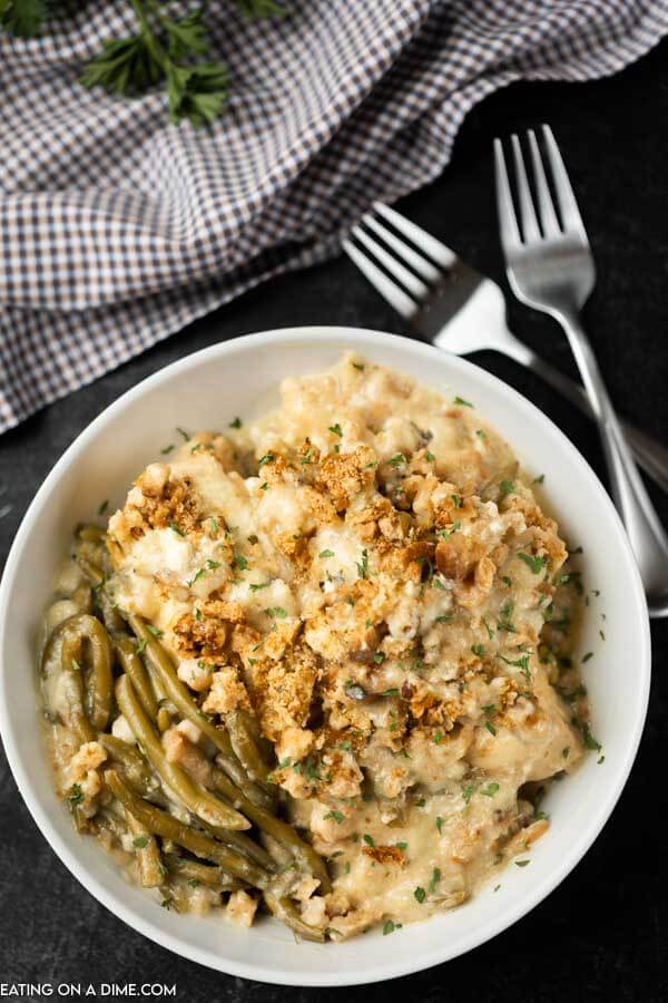 Close up image of a bowl of chicken and stuffing with two forks. 