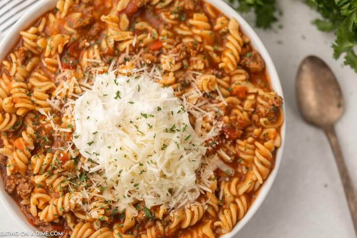Close up image of a bowl of lasagna soup with a spoon. 