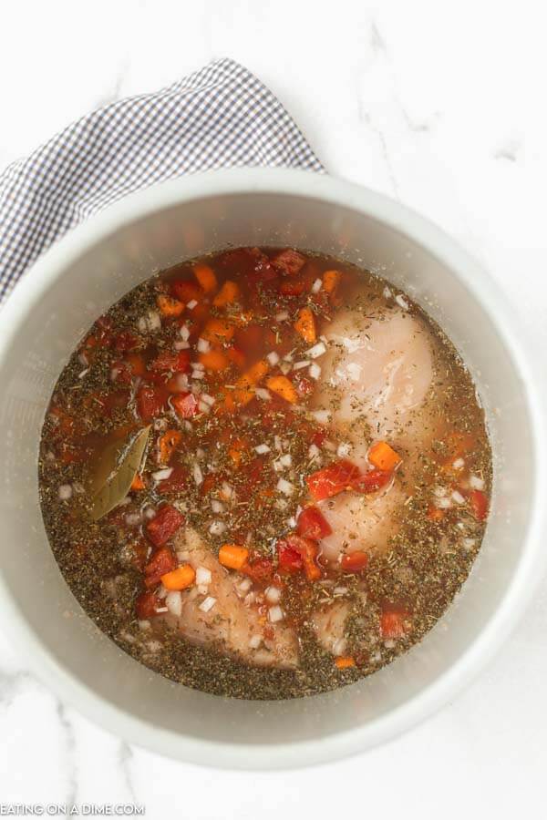 Close up image of Italian Chicken Soup in instant pot in process. 