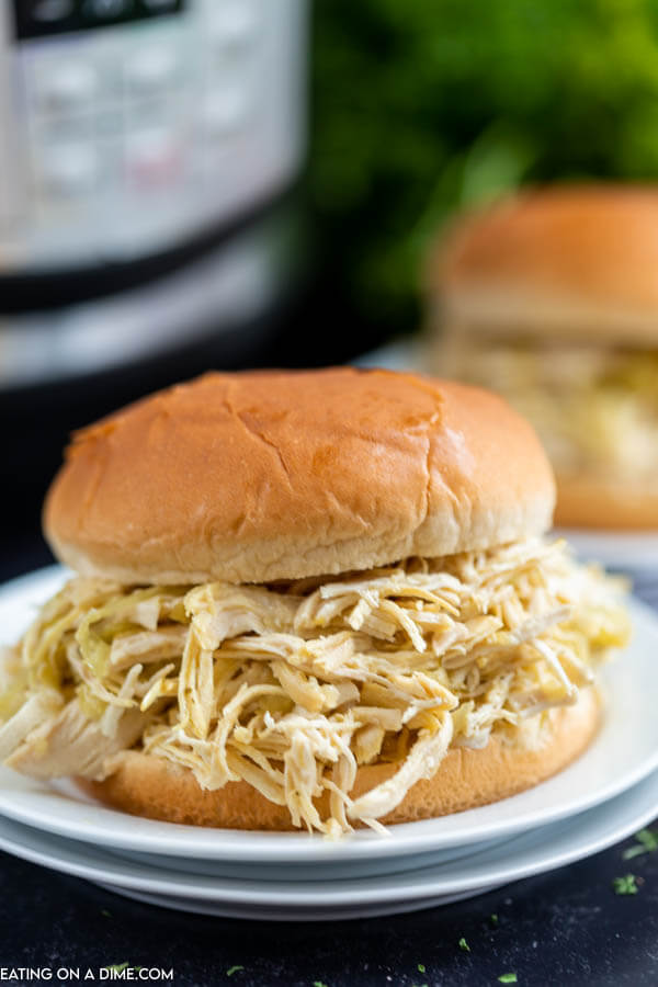 A Mississippi Chicken Sandwich on a white plate in front of an Instant pot. 