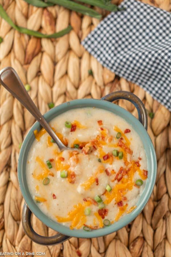 bowl of loaded baked potato soup with cheese and bacon on top.